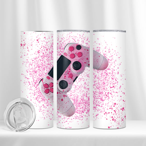 A 20 oz tumbler with a playful pink splatter design and a central image of a pink gaming controller, combining a love for gaming with a trendy aesthetic.