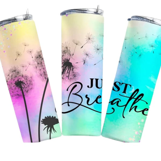 White tumbler with a calming 'Just Breathe' message, dandelion silhouettes, and a gradient of pastel colors promoting mindfulness and relaxation.